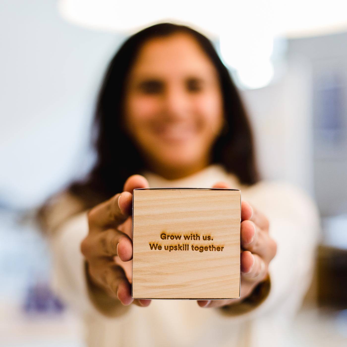 blurred woman showing cube with writing 