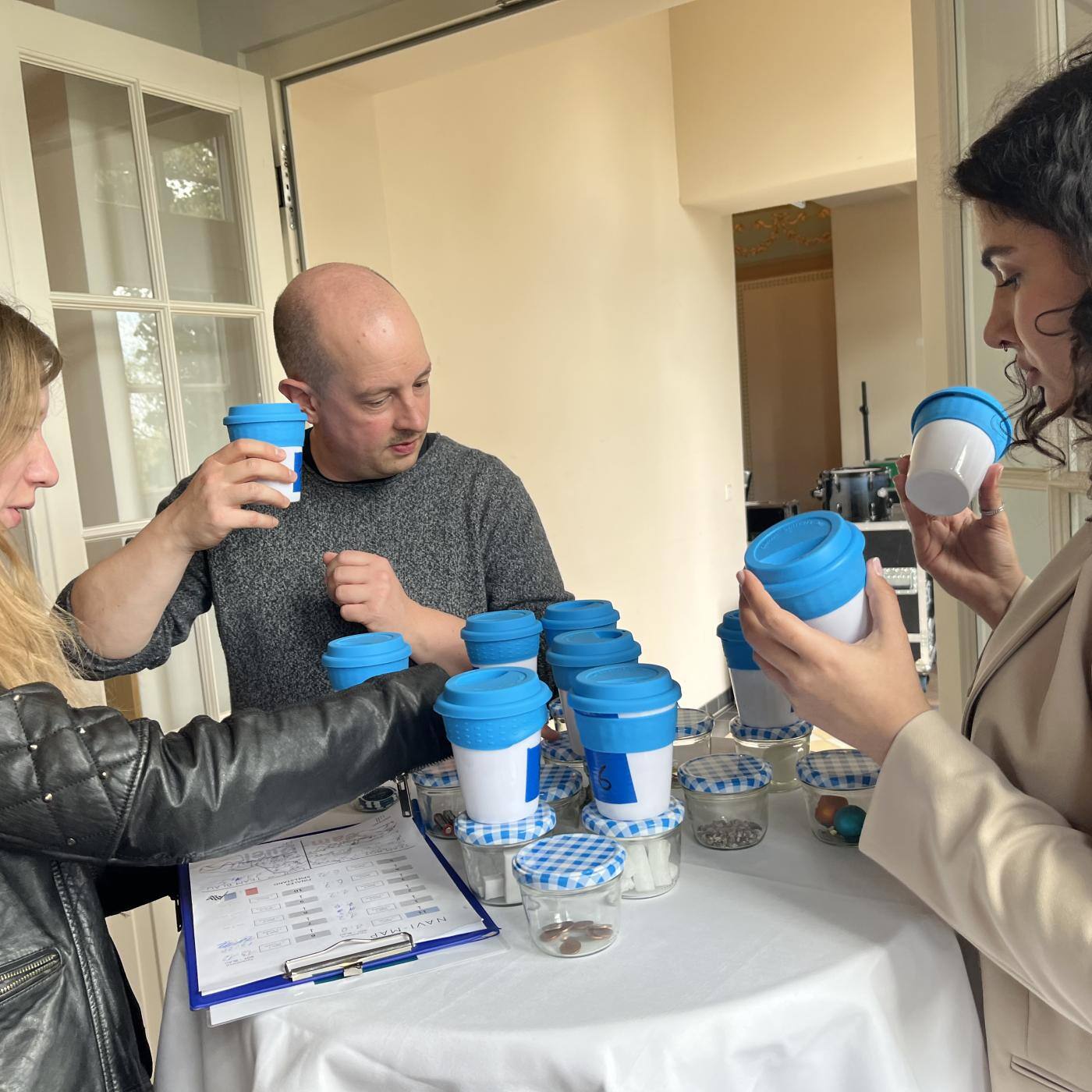 group of people playing game with cups